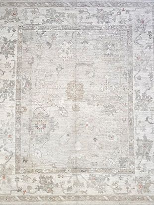 A close up of a white rug with a floral pattern on it.