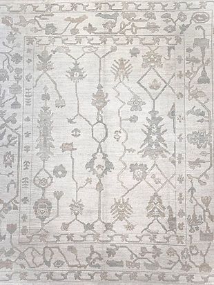 A white rug with a floral pattern on it.