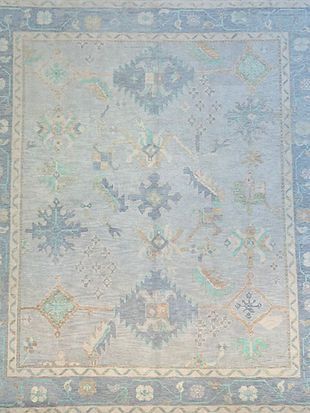A close up of a rug with a floral pattern on it.