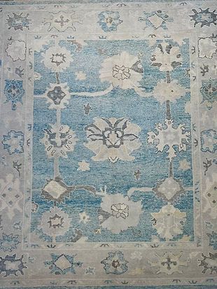 A blue and white rug with a floral pattern on it