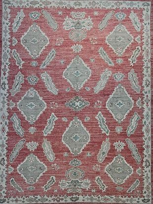 A red and gray rug with a pattern on it.