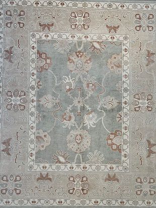 A rug with a floral pattern on it is sitting on a table.