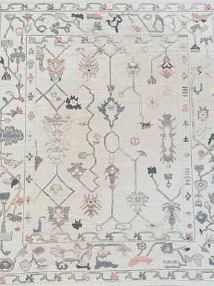 A white rug with a floral pattern on it