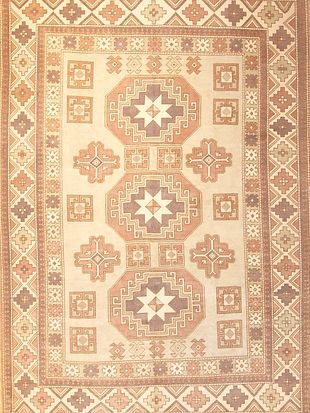A rug with a geometric pattern on it is sitting on a table.
