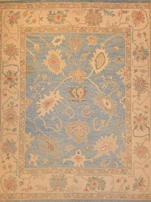 A blue and white rug with a floral pattern on it.