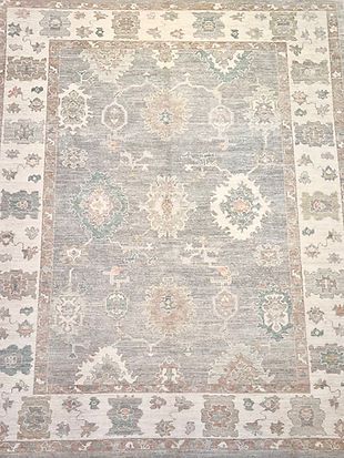 A large rug with a floral pattern on it is sitting on a table.