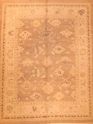 A rug with a floral pattern on it is on a wooden floor.