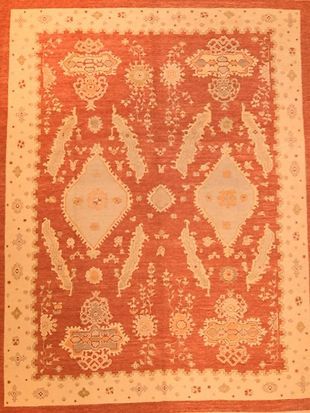 A rug with a pattern of flowers and leaves on it