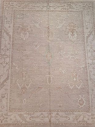 A close up of a rug with a floral pattern on it.