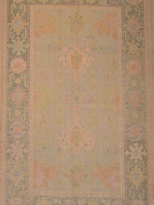 A rug with a floral pattern on it is sitting on a table.