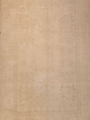 A close up of a beige rug with a square pattern on it.