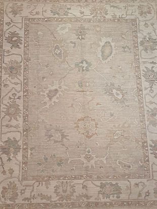 A rug with a floral pattern on it is sitting on a table.