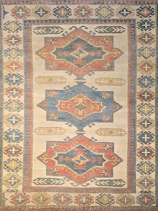 A rug with a geometric pattern on it is sitting on a table.