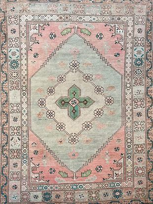 A close up of a rug with a floral pattern on it.