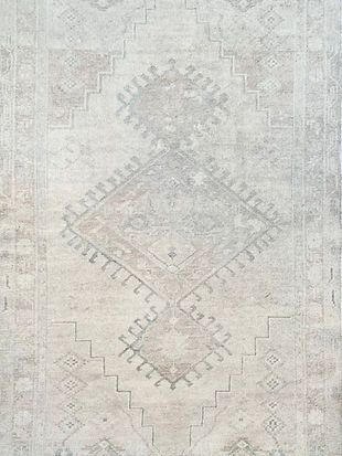A close up of a white rug with a pattern on it.