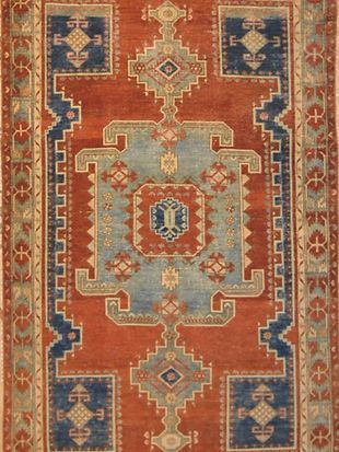 A red and blue rug with a geometric pattern
