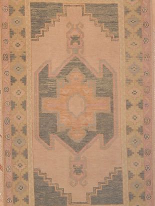 A rug with a geometric pattern on it is sitting on a table.