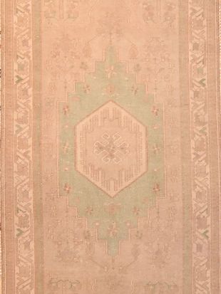 A close up of a rug with a pattern on it.