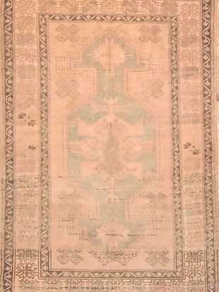 A close up of a rug with a cross on it.
