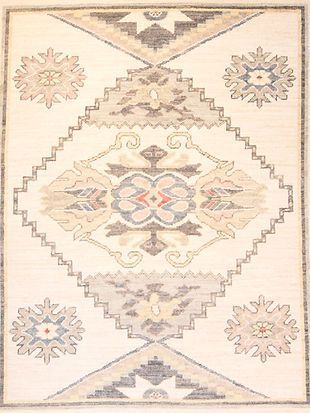 A white rug with a geometric pattern on it.