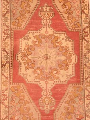 A red and white rug with a floral pattern on it