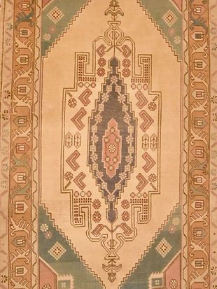 A close up of a rug with a pattern on it