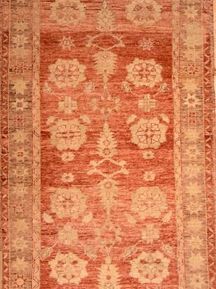 A close up of a rug with a floral pattern on it.