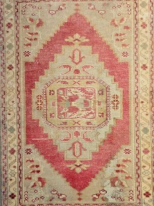 A rug with a geometric pattern on it is sitting on a table.