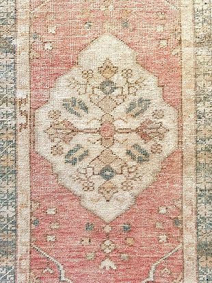 A close up of a rug with a floral pattern on it.