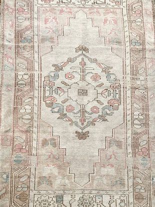 A close up of a rug with a floral pattern on it.