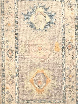 A close up of a rug with a floral pattern on it.