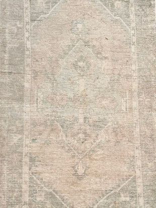 A close up of a rug on a wall.