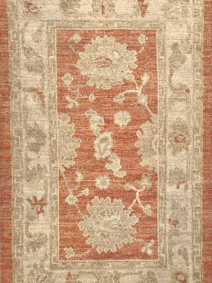 A close up of a rug with a floral pattern on it.