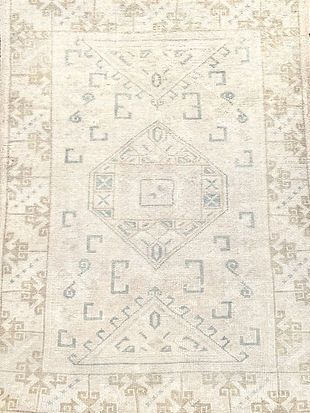 A rug with a geometric pattern on it is sitting on a table.