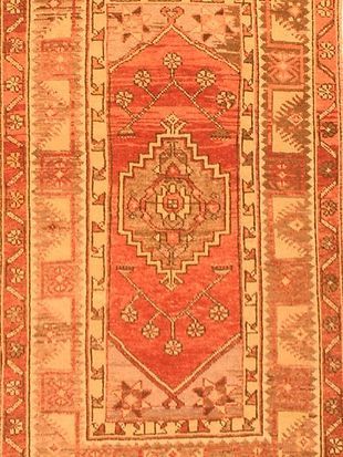 A red rug with a geometric pattern on it