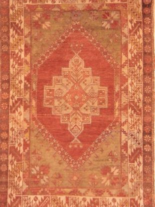 A red rug with a geometric pattern on it