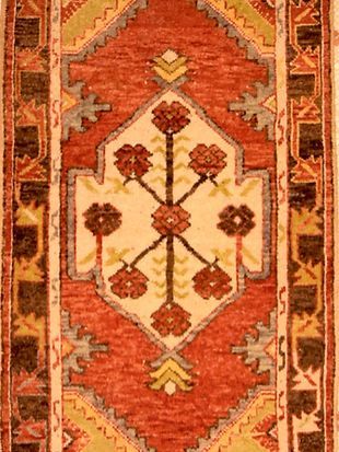 A close up of a rug with a floral pattern on it