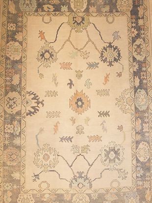 A rug with a floral pattern on it is on a wall.