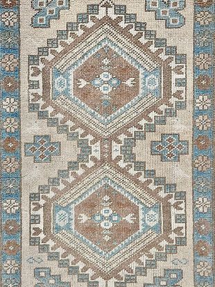 A close up of a rug with a geometric pattern on it.