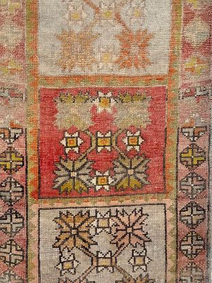 A close up of a rug with a floral pattern on it.