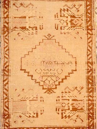 A rug with a geometric pattern and arabic writing on it