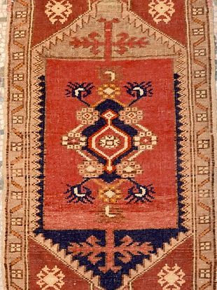 A red rug with a blue and white pattern on it.