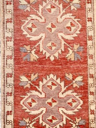 A close up of a rug with a floral pattern on it.