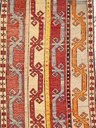 A close up of a rug with a pattern on it.