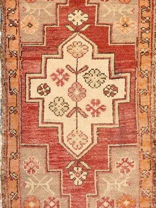 A close up of a rug with a floral pattern on it.