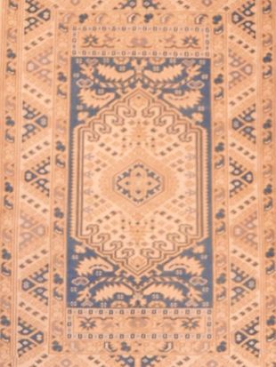 A brown and blue rug with a floral pattern
