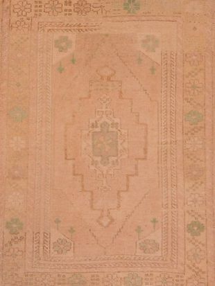 A close up of a pink rug with a pattern on it.