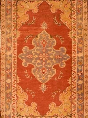A red rug with a floral pattern on it