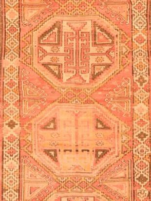 A close up of a rug with a geometric pattern on it.
