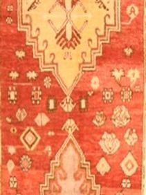 A red and yellow rug with a pattern on it